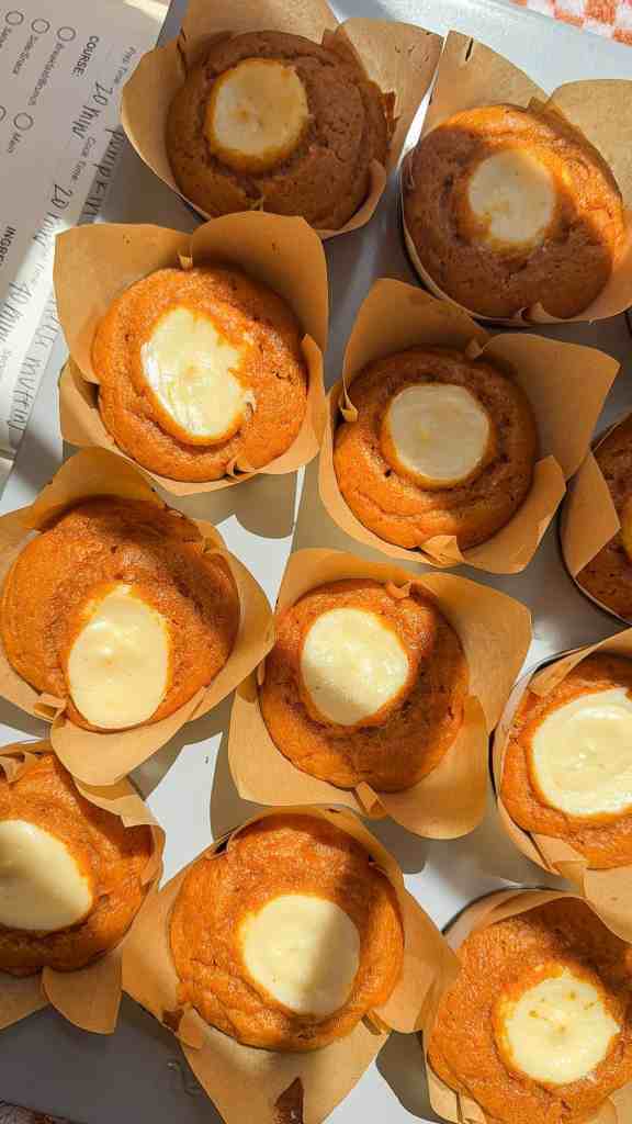 pumpkin cream cheese muffins cooling on rack