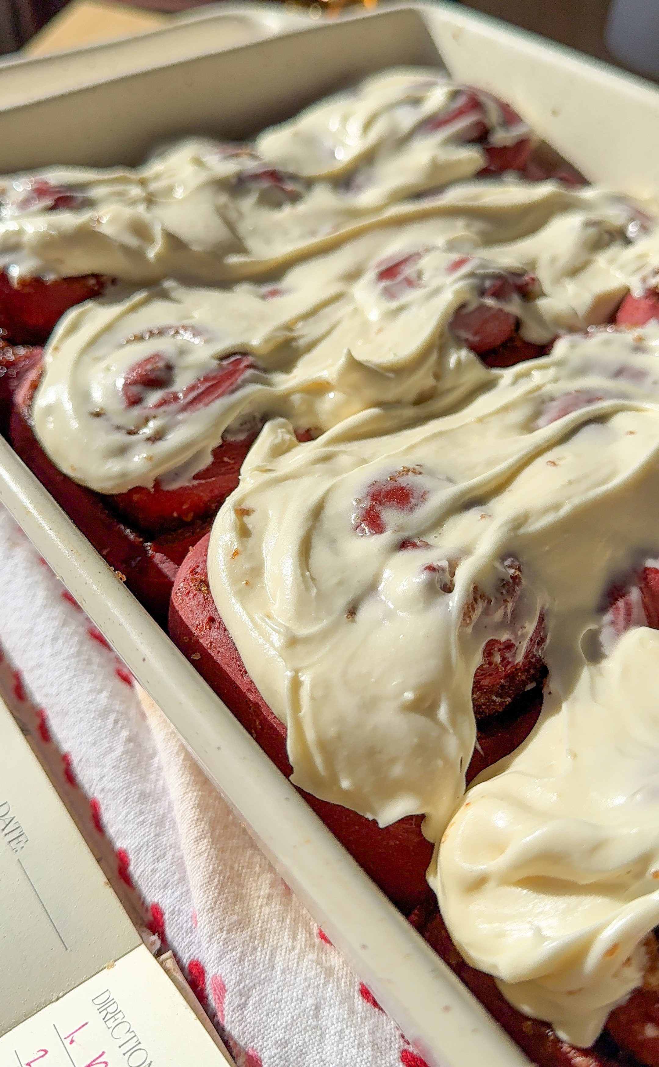 freshly iced red velvet cinnamon rolls ready to be enjoyed for brunch