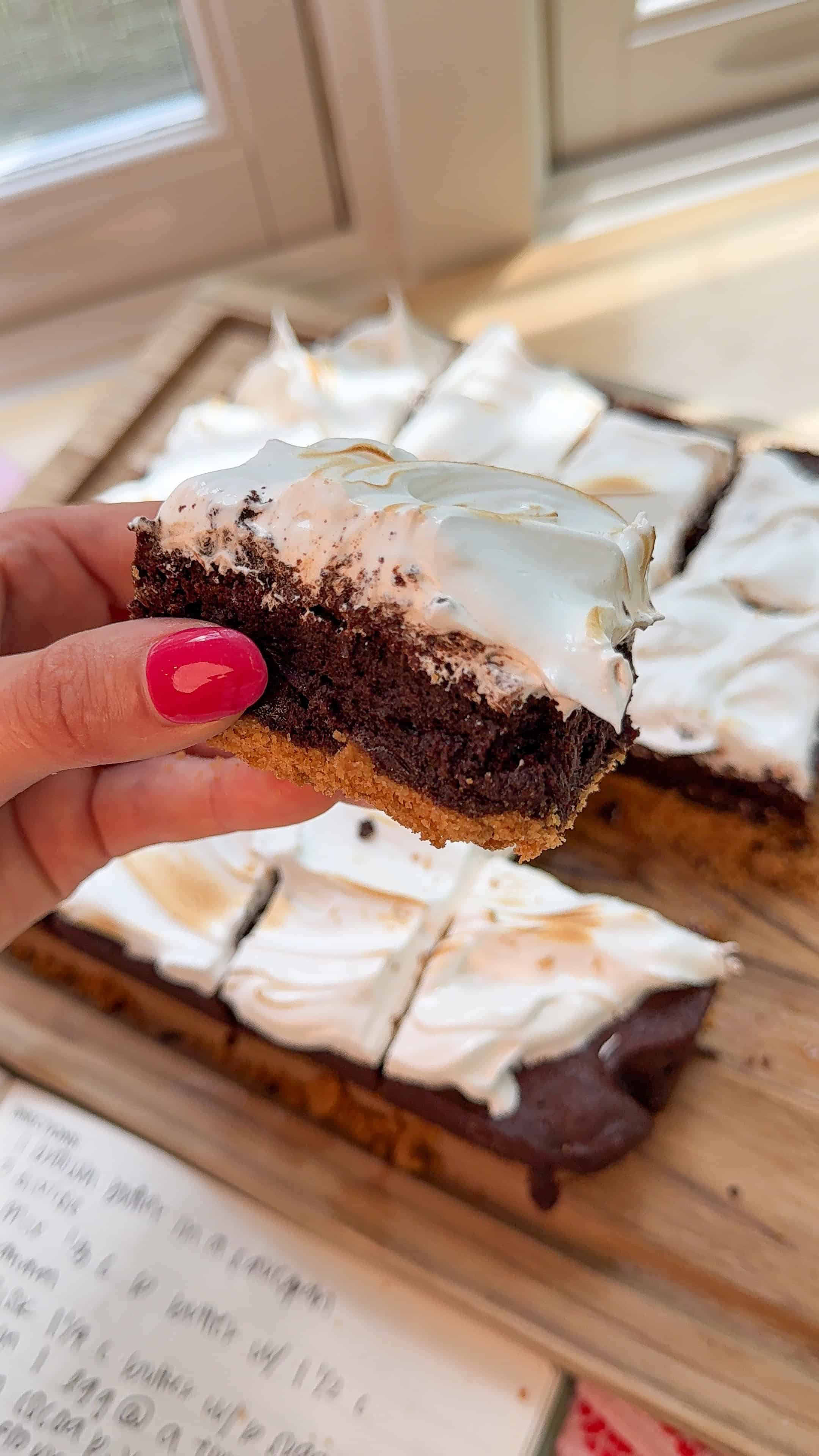me holding a slice of my brown butter smores brownies