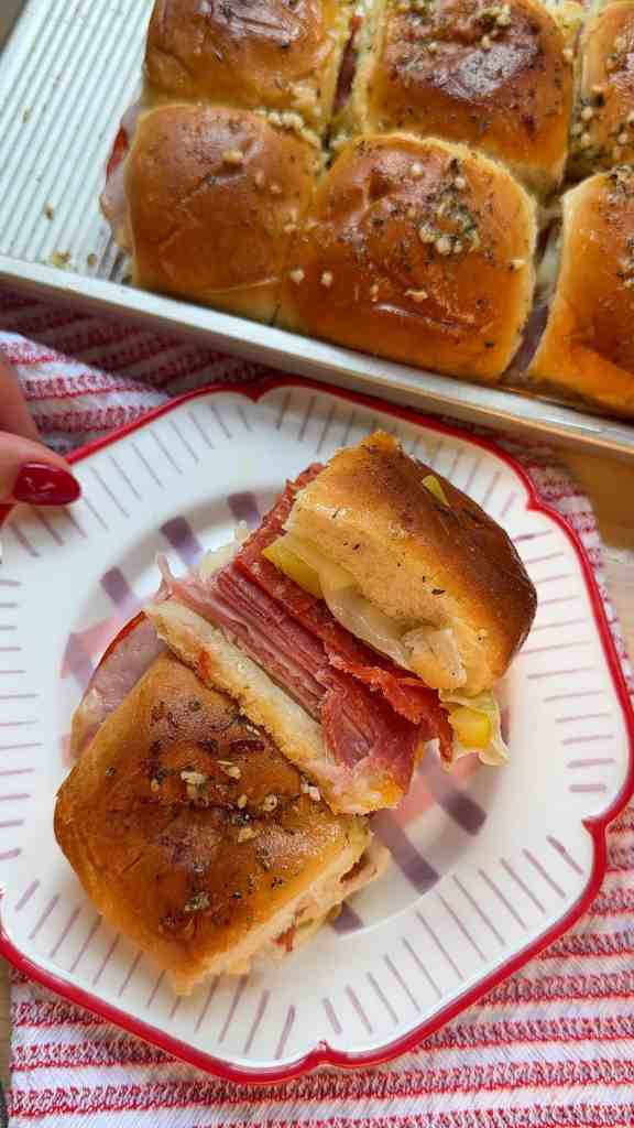 italian sub sliders on a plate stacked on top of each other