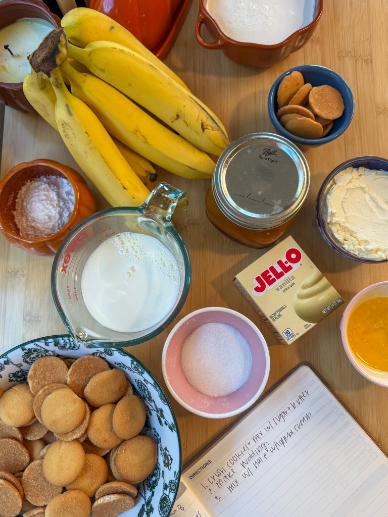 Ingredients for banana pudding pie including vanilla wafers, bananas, cream cheese, instant vanilla pudding, heavy cream, and caramel